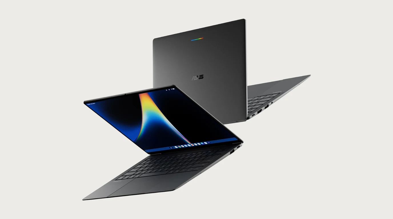 Two Asus Googlebooks floating at an angle against a plain light background, one open with its screen showing a colorful ribbon wallpaper and the other turned away to show the dark lid with the rainbow Glowbar.